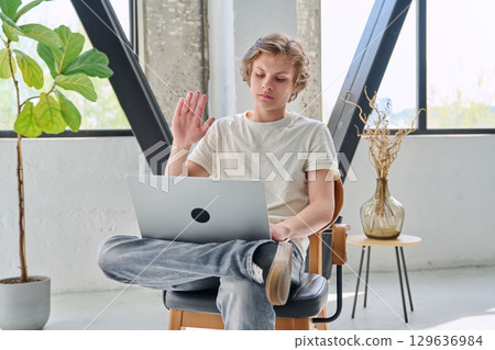 Teenage boy using laptop for video conference, online meeting 129636984