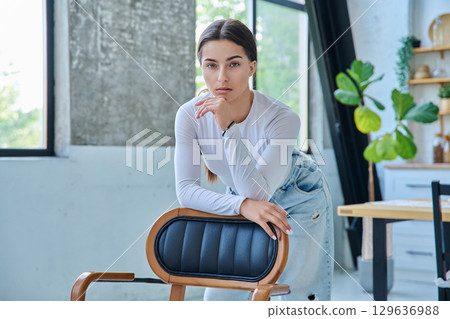 Portrait of beautiful stylish young teenage girl posing at home 129636988