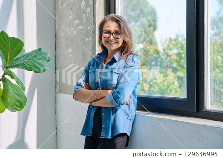 Portrait confident middle aged woman posing with crossed arms 129636995