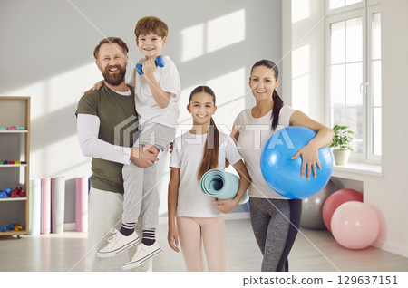 Happy sporty family with gear group portrait. Sporty family choose fitness setting positive example for children cultivating sense of joy togetherness through shared athletic pursuits sporty family. 129637151