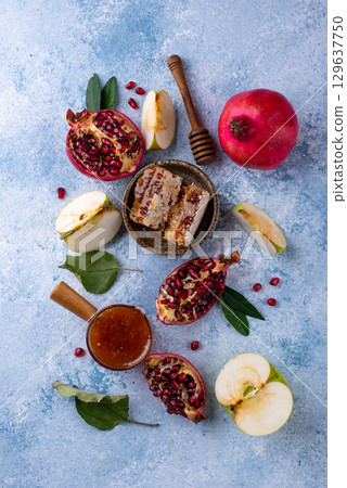 Rosh Hashana concept with honey, apple and pomegranate Rosh Hashana concept with honey, apple and pomegranate 129637750