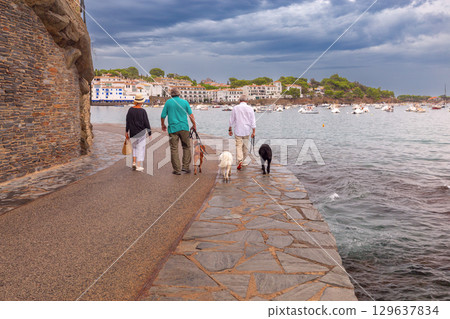 People walking dogs by the sea in Cadaques, Spain People walking dogs by the sea in Cadaques, Spain 129637834