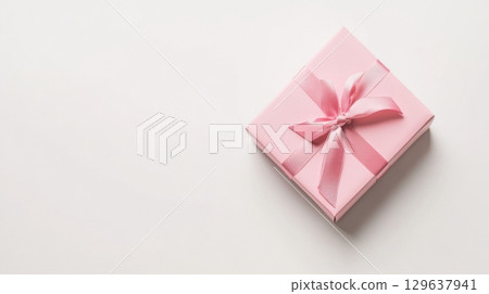 Square gift box in guava color with matte paper and satin ribbon bow isolated on white background for celebration and branding mockups Square gift box in guava color with matte paper and satin ribbon bow isolated on white background for celebration and branding mockups 129637941