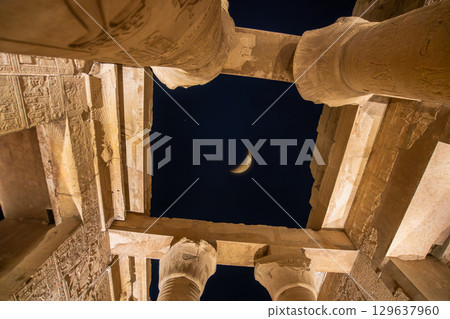 Crescent moon above Temple of Kom Ombo columns at night Egypt. 129637960