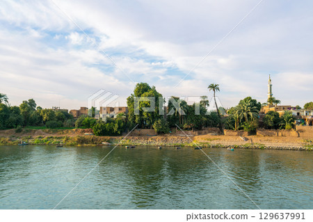 Lush Riverbank Landscape of Esna on the Nile River in Egypt. Lush Riverbank Landscape of Esna on the Nile River in Egypt. 129637991