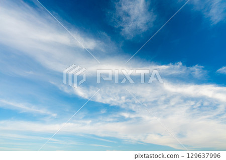 Dramatic Wispy Clouds in a Clear Blue Sky Over the Nile River. Dramatic Wispy Clouds in a Clear Blue Sky Over the Nile River. 129637996
