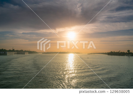 Golden Sunset Over the Nile River Near Esna Lock, Egypt. Golden Sunset Over the Nile River Near Esna Lock, Egypt. 129638005