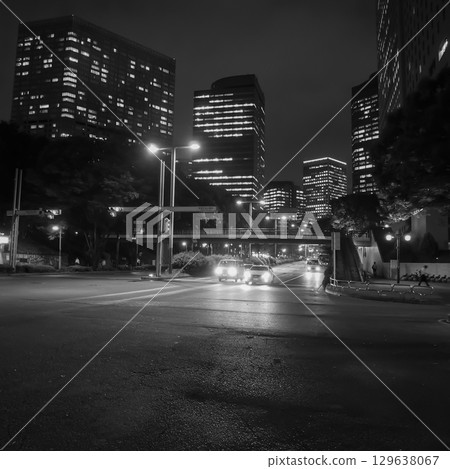 Nishi-Shinjuku at night, illuminated by skyscrapers and streetlights. 129638067