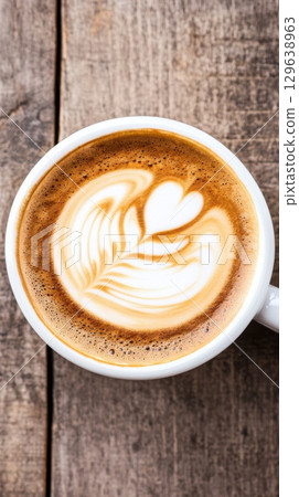 Vertical cappuccino photo with latte art and ink swirl overlay blending photography and drawing 129638963