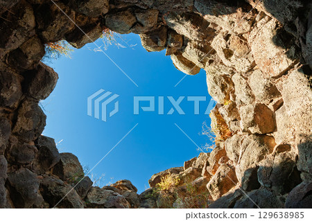 Stone interior of ancient Nuraghe tower with open sky view in Sardinia Stone interior of ancient Nuraghe tower with open sky view in Sardinia 129638985