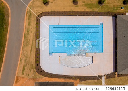 New community swimming pool features multiple lanes spacious deck in suburban area 129639125