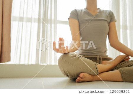 Engaging in a tranquil meditation practice under bright and refreshing natural light Engaging in a tranquil meditation practice under bright and refreshing natural light 129639261