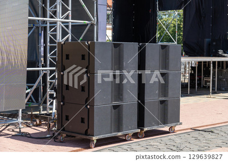Professional concert acoustic systems set up on an open-air stage Professional concert acoustic systems set up on an open-air stage 129639827
