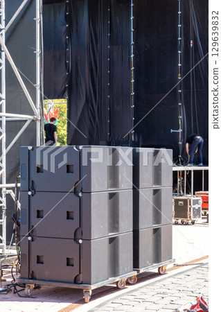 Professional concert acoustic systems set up on an open-air stage 129639832