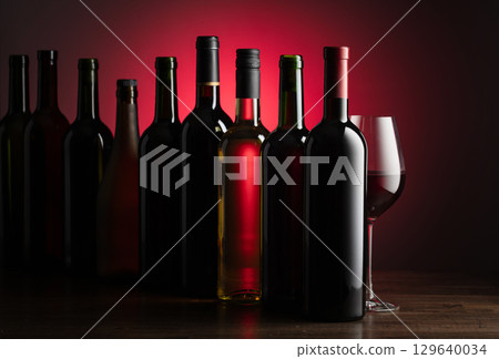 Bottles of wine on a old wooden table. 129640034