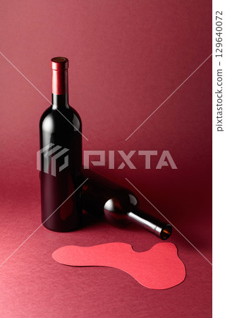 Bottles of red wine on a red background. Bottles of red wine on a red background. 129640072