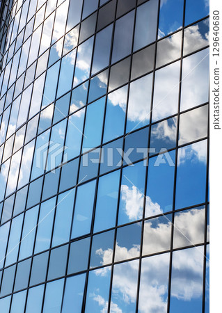 Reflections of Sky on Modern Glass Building Facade Reflections of Sky on Modern Glass Building Facade 129640680