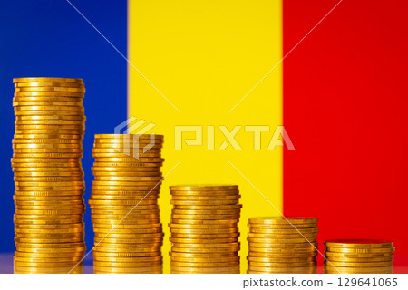 Stacks of gold coins from highest to lowest with flag of Romania on the background. Concept of economic decrease, fall, crash. Negative financial rate in Romania Stacks of gold coins from highest to lowest with flag of Romania on the background. Concept of economic decrease, fall, crash. Negative financial rate in Romania 129641065