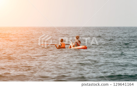 Two People Kayaking in the Ocean Two People Kayaking in the Ocean 129641164