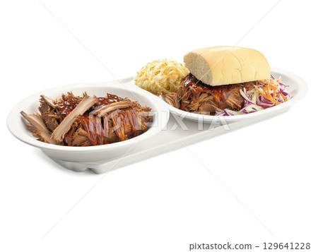 Pulled Pork BBQ Plate A plate of pulled pork with BBQ sauce, coleslaw, and cornbread. The pork has a smoky, 129641228