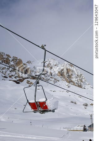 Snowy mountain ski-lift no people, blue sky, azure, air, freshness, ecology. High quality photo Snowy mountain ski-lift no people, blue sky, azure, air, freshness, ecology. High quality photo 129643047