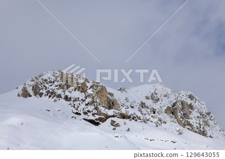 Snowy mountain ski-lift no people, blue sky, azure, air, freshness, ecology. High quality photo Snowy mountain ski-lift no people, blue sky, azure, air, freshness, ecology. High quality photo 129643055