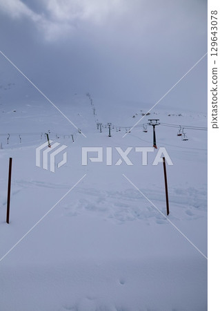 Snowy mountain ski-lift no people, blue sky, azure, air, freshness, ecology. High quality photo 129643078