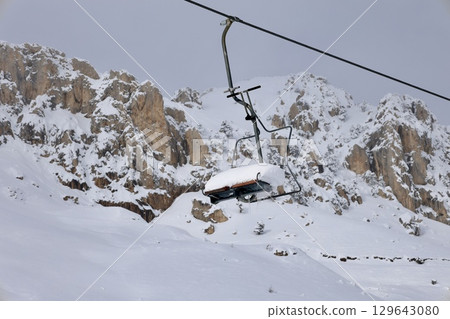 Snowy mountain ski-lift no people, blue sky, azure, air, freshness, ecology. High quality photo 129643080