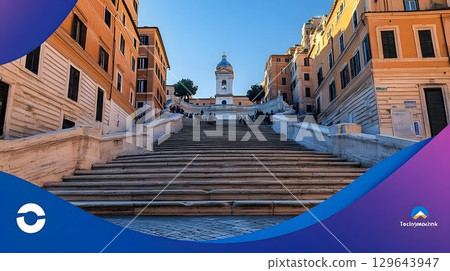 Historic city staircase leading to clock tower under sunny sky Historic city staircase leading to clock tower under sunny sky 129643947