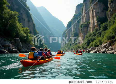 Groups of enthusiastic individuals glide smoothly across clear turquoise waters, navigating the breathtaking canyon landscape under a bright midday sun while kayaking. 129644479