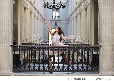 Ballerina posing gracefully on balcony at Passage Pommeraye in Nantes Ballerina posing gracefully on balcony at Passage Pommeraye in Nantes 129644740