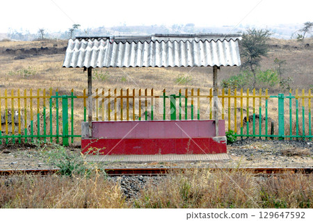 Small Rural Railway Platform with Bench and Shed in Countryside 129647592