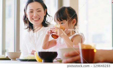 Breakfast scene of three parents and children 129648283