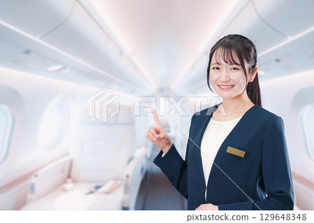 A woman working as a flight attendant on a private jet A woman working as a flight attendant on a private jet 129648348