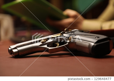 Revolver on a Table in police station 129648477