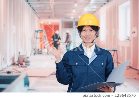 A young male worker working at an interior construction site A young male worker working at an interior construction site 129648570