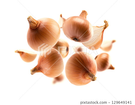 Ripe Golden onion levitates on a white background 129649141