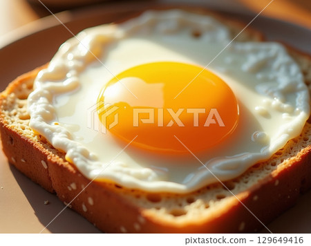 Delicious Close-up Fried Egg on Toast with Golden Yolk Breakfast Food 129649416
