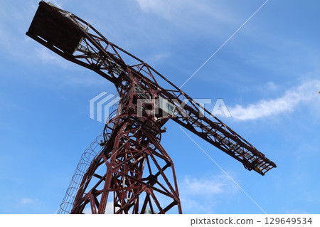 Shipyard cranes against the blue sky Shipyard cranes against the blue sky 129649534