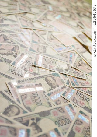 A pile of 10,000 yen bills A pile of 10,000 yen bills 129649673