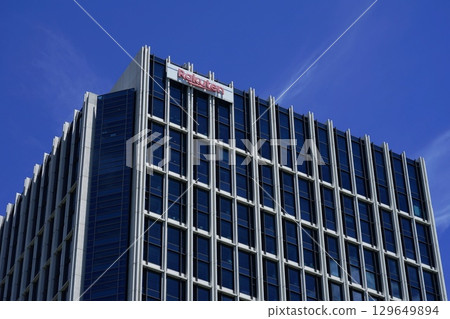 A high-rise building shining against a beautiful blue sky with clouds. July Setagaya 1380 Rakuten Headquarters 129649894