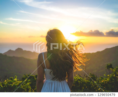 woman lit by the setting sun woman lit by the setting sun 129650479