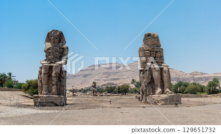 The Colossi of Memnon Standing Against a Mountainous Backdrop The Colossi of Memnon Standing Against a Mountainous Backdrop 129651732