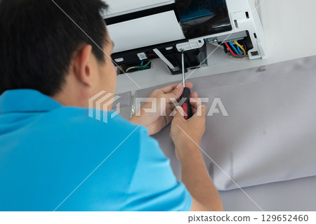 Electrician man repair and maintenance air conditioner Electrician man repair and maintenance air conditioner 129652460