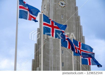 Hallgrimskirkja Church and the national flag, a landmark in the capital city of Reykjavik, a Nordic island nation in Iceland Hallgrimskirkja Church and the national flag, a landmark in the capital city of Reykjavik, a Nordic island nation in Iceland 129652544