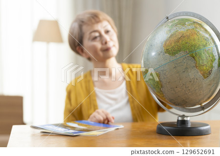 Senior woman looking forward to planning a trip 129652691