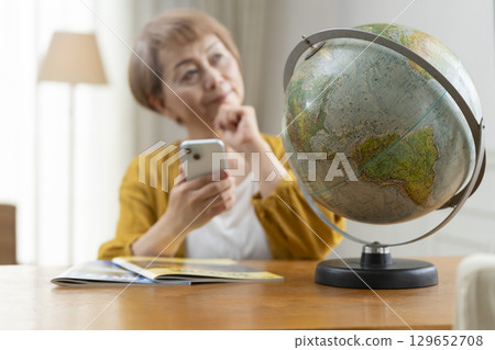Senior woman looking forward to planning a trip 129652708