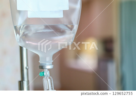 Close up medical intravenous IV drip in hospital background 129652755
