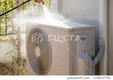 air conditioning compressor outdoor unit cleaning service with water spray 129652756