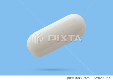 White medicine pill tablet float on blue background White medicine pill tablet float on blue background 129653053